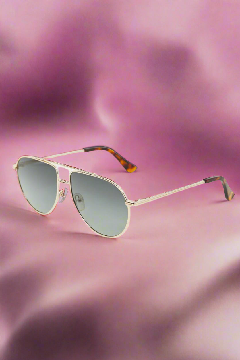 Solis aviator sunglasses radiating golden hour warmth — timeless, bold, and made for the woman who owns her light.