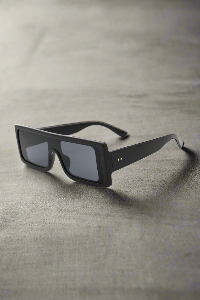 Supanova sunglasses in black with sleek polycarbonate frame and UV400 lenses, exuding modern chic and fierce confidence on a clean backdrop.