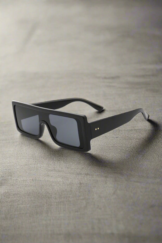 Supanova sunglasses in black with sleek polycarbonate frame and UV400 lenses, exuding modern chic and fierce confidence on a clean backdrop.